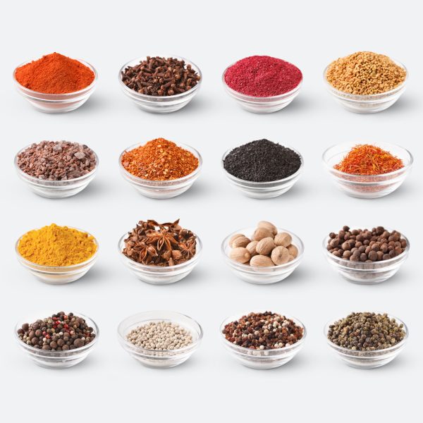 Collection of different spices and condiments in glass bowls isolated on white background